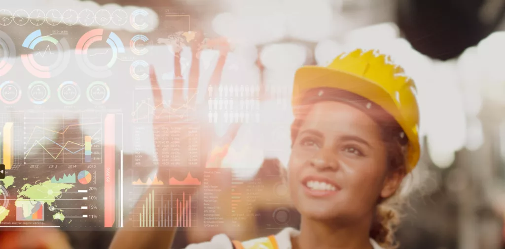 stock photo of women in hard hat looking at data